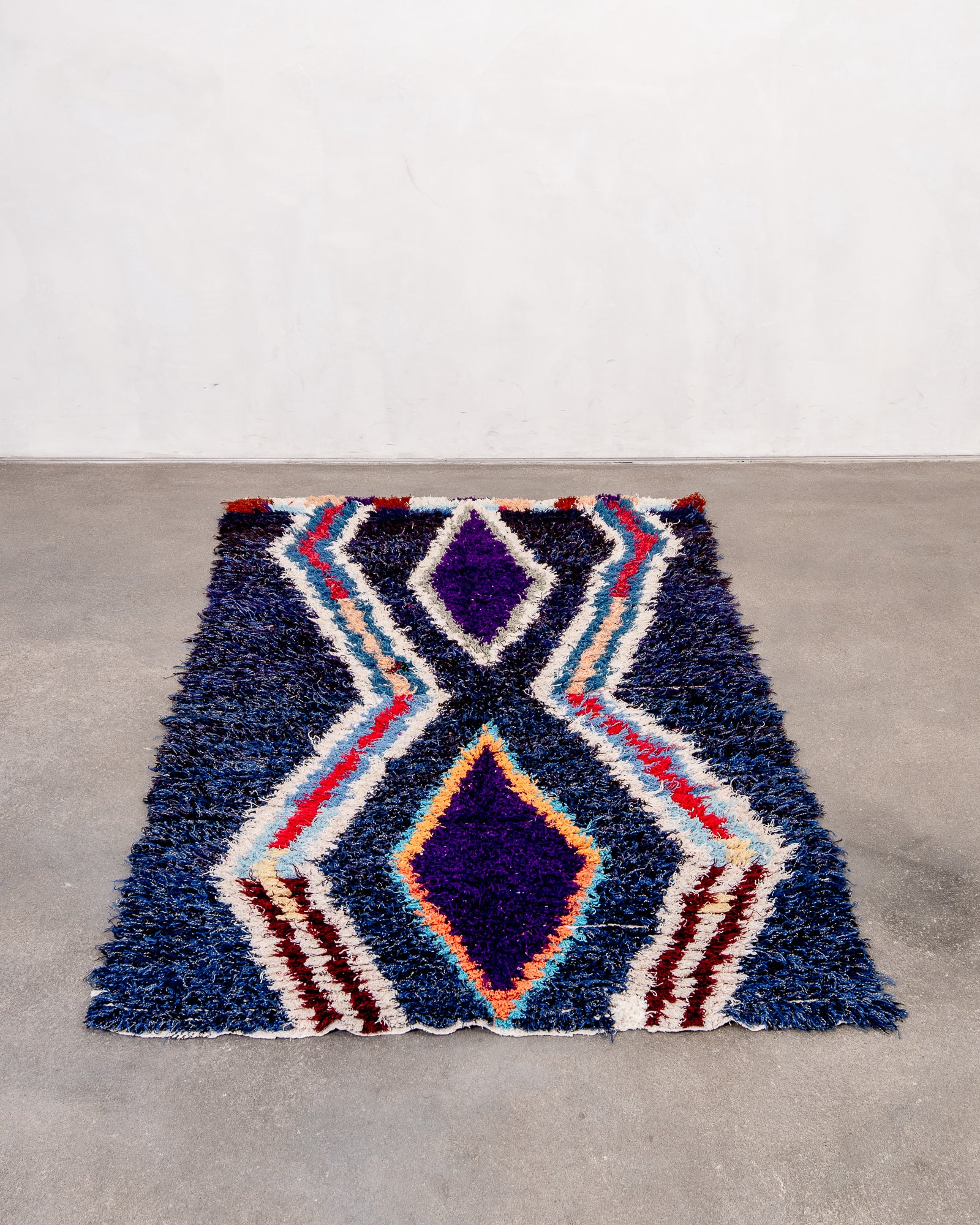 Vintage, handcrafted Berber rug from Morocco. Boucherouite carpet with beautiful colours and patterns and heavy cotton texture.